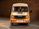 an orange and white truck parked in front of a brick wall