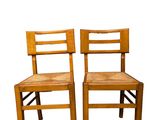 pair of wooden chairs on a white background with a white background