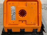 an orange box with a fan on top of it sitting on a table