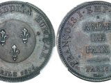 a close up of a coin with a cross on it