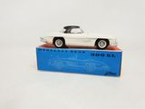 a white model car sitting on top of a blue box