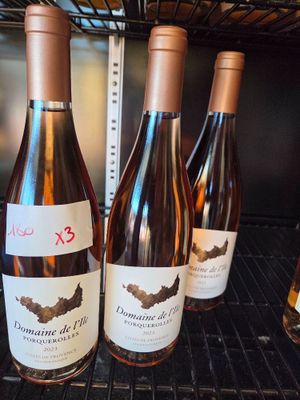several bottles of wine are lined up on a shelf in a wine cellar