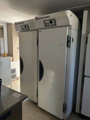 three white refrigerators in a kitchen next to each other