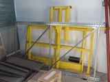 a room with a lot of boxes and ladders in it