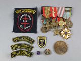 several military badges and medals are displayed on a table