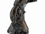 bronze statue of a girl with an umbrella on a pedestal