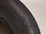 the tire of a car that is sitting on the side of the road
