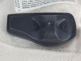 a black remote control sitting on top of a white cloth