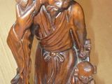 a statue of a woman holding a bird on a table