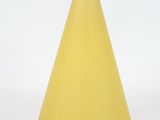 a yellow cone shaped lamp on a white surface