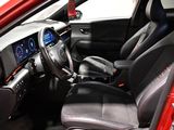 the interior of a red car with black seats and a steering wheel