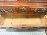 a wooden dresser with a drawer underneath it