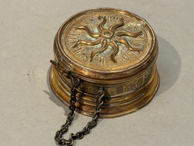 a gold box with a chain around it on a table