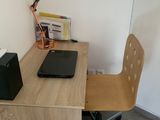 a desk with a chair and a laptop on it