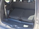 two seats in the back of a car with luggage in the trunk