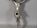a silver statue of a man on a cross on a table