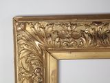 a picture of a gold framed mirror on the wall