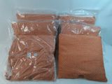 three bags of brown pillows sitting on top of a white table