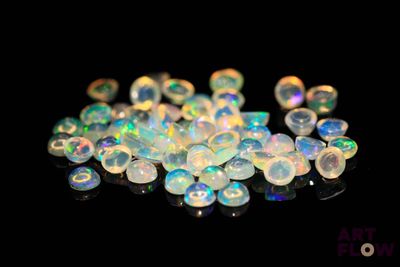 white fire oplites are scattered on a black surface
