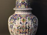 a large vase with a bird on top of it