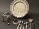 a silver plate with spoons, forks, and spoons on a table