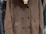a coat hanging on a rack in a clothing store