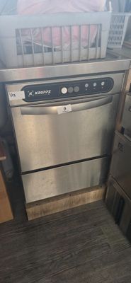 a dishwasher that is in the middle of a kitchen
