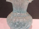 a glass vase that is sitting on a table