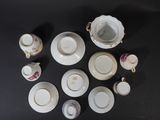 many cups and saucers sitting on a table