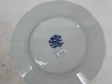 a white plate with a blue tree on it