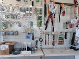 many tools hanging on the wall in the store