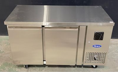 two stainless steel refrigerators sitting on top of each other in a room