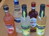 many bottles of alcohol sitting on a counter top