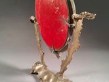 an image of a gold and red object on a stand