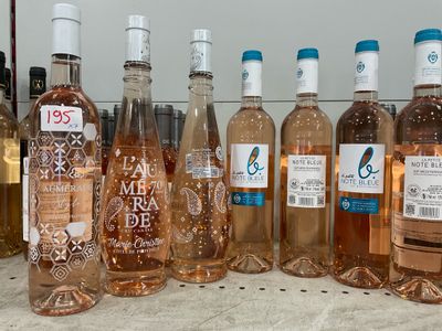 several bottles of rose wine are lined up on a counter