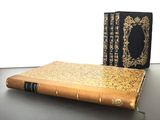 two old books sitting on a table next to each other