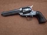 a close up of a revolver on a brown background