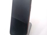 a cell phone that is sitting on top of a stand