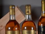 three bottles of wine sitting on a table next to each other