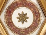 an image of a gold and white clock with a red and gold design