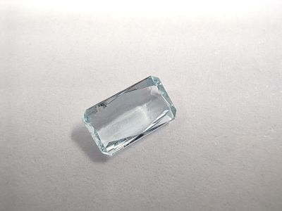 a close up of an aquamarine stone on a white surface