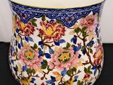 a vase that has flowers on it on a table