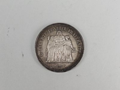a close up of a coin on a white surface with a white background