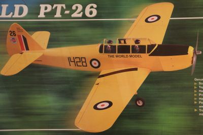 a model of a yellow plane flying in the sky