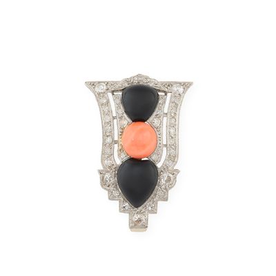 a close up of an orange and black broochle on a white background