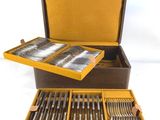 a brown box with silverware in it on a white surface