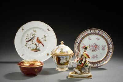 several plates and bowls are sitting on a table with a bird on them