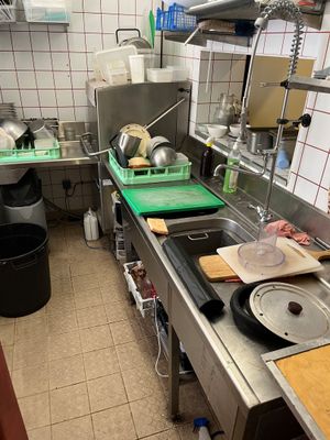 a kitchen with a lot of counter space and a lot of pots and pans