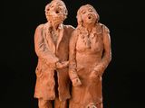 an image of a statue of a man and woman with a dog