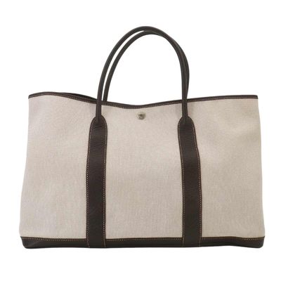 a white and brown tote bag sitting on top of a white surface